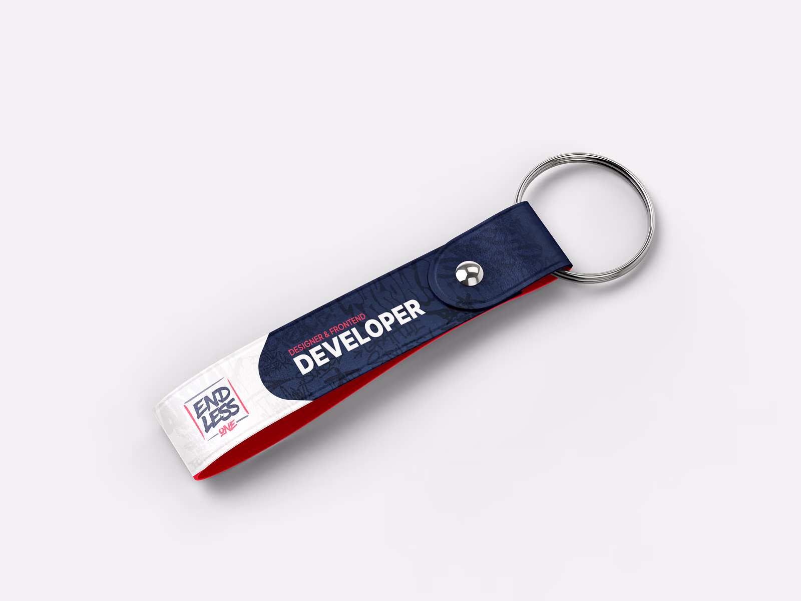 Keychain with dark blue and white graffiti design and Endless One lettering on the underside.
